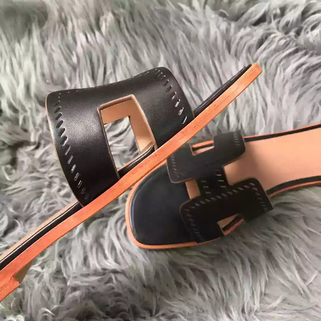 HERMES ORAN SLIDE SANDALS IN BLACK SWIFT PERFORATED CALFSKIN – HMSD100