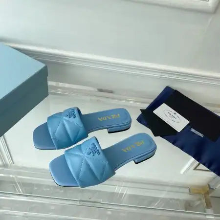 PRADA WOMEN’S SLIDES SANDALS IN LIGHT BLUE NAPPA LEATHER – PSD075